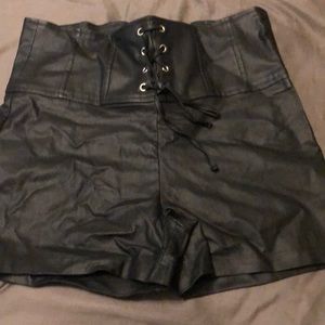 Black high waisted faux leather shorts.